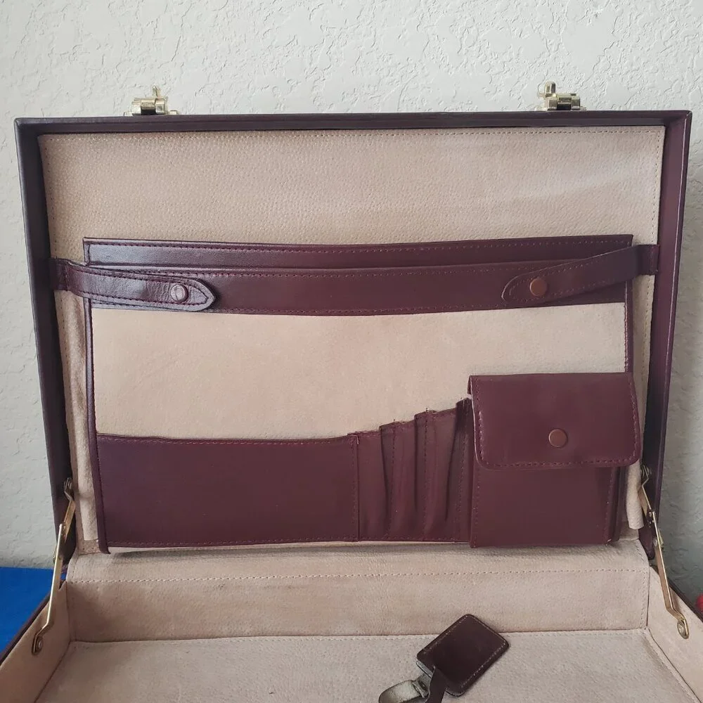 Burgundy leather attaché briefcase with a three-digit combination lock and gold-